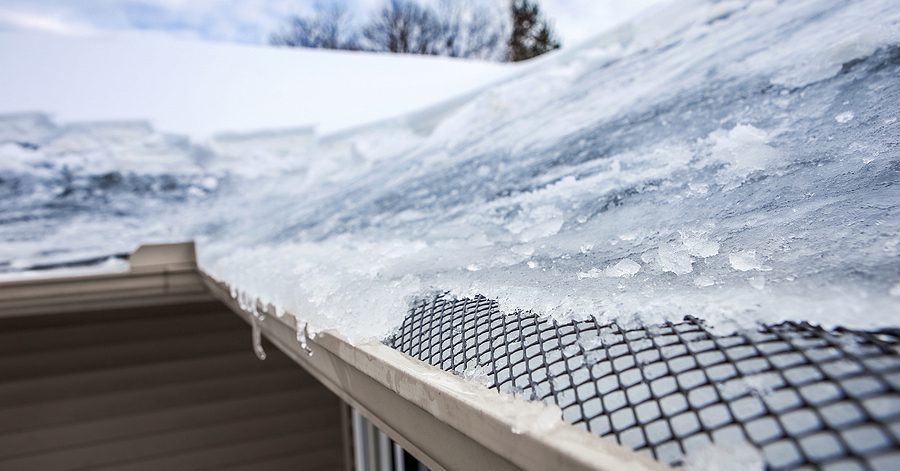 Ice on frozen roof and gutters