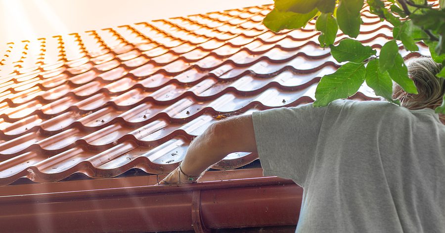 Man clearing gutters